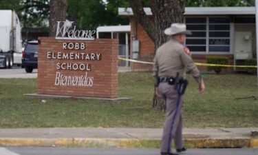 An officer walks outside of Robb Elementary School in Uvalde