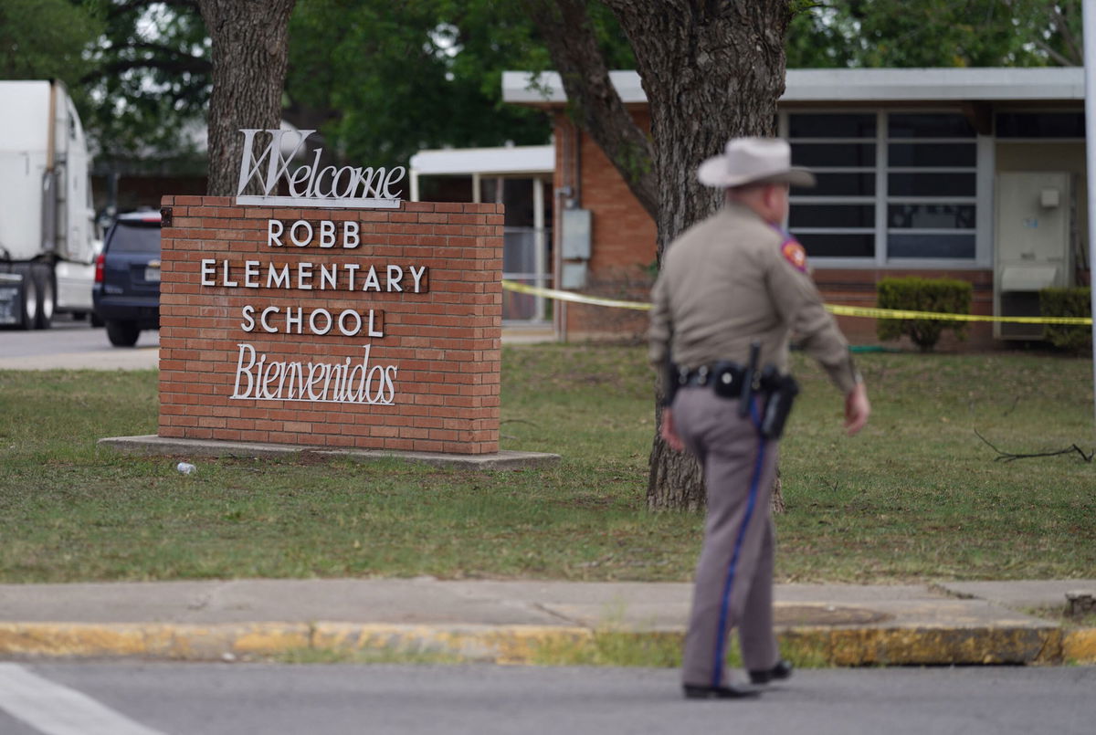 <i>Allison Dinner/AFP/Getty Images</i><br/>An officer walks outside of Robb Elementary School in Uvalde