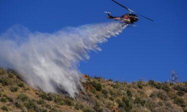 A helicopter drops water on the Sheep Fire burning in Wrightwood