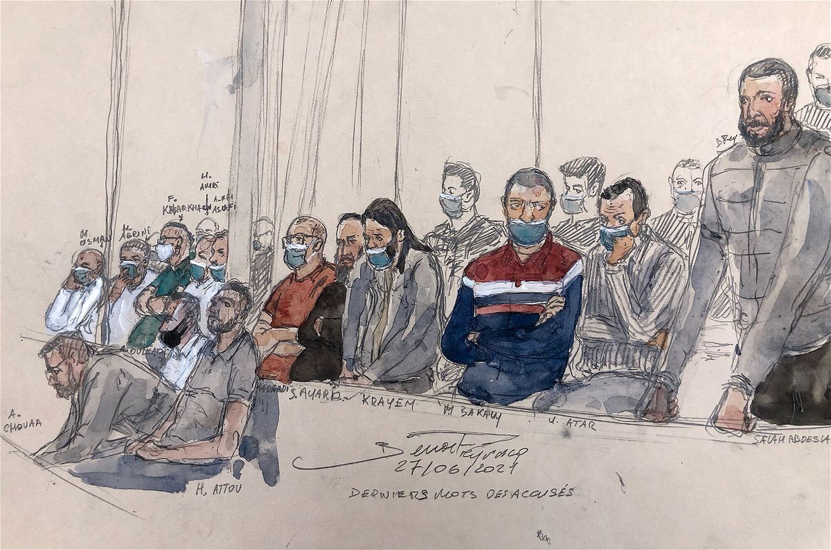 <i>Benoit Peyrucq/AFP/Getty Images</i><br/>This court-sketch made on Monday shows defendant Salah Abdeslam (right) standing next to the 13 other defendants in front of Paris' criminal court during the trial of the November 2015 attacks that saw 130 people killed.