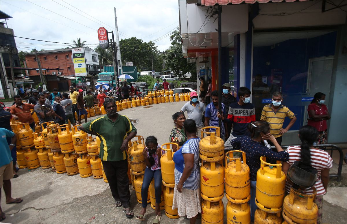 <i>NurPhoto/Getty Images</i><br/>People wait to buy Liquefied Petroleum Gas (LPG) cylinders in Nawagamuwa near Colombo