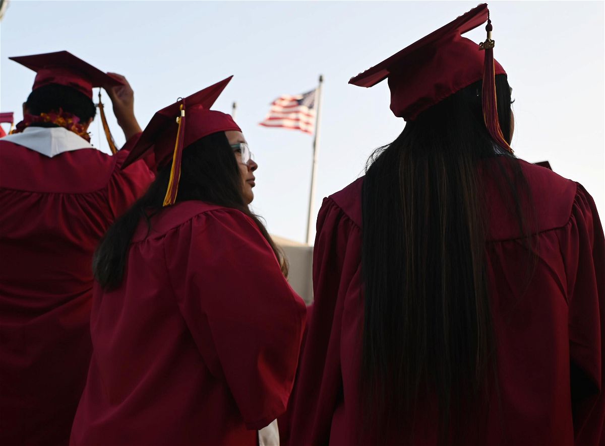 <i>ROBYN BECK/AFP/Getty Images</i><br/>A US flag flies as students earning degrees at Pasadena City College participate in the graduation ceremony