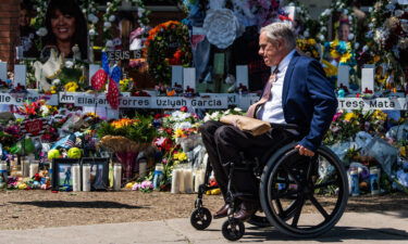 Texas Gov. Greg Abbott visits a makeshift memorial outside Robb Elementary School on May 29.