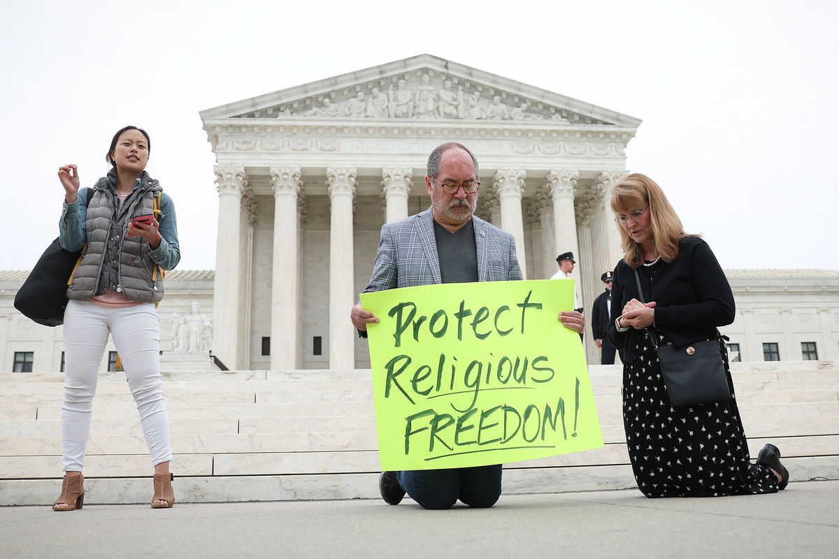 <i>Win McNamee/Getty Images</i><br/>Demonstrators kneel in prayer outside the U.S. Supreme Court as the case of former Bremerton High School assistant football coach Joe Kennedy is argued before the court April 25 in Washington