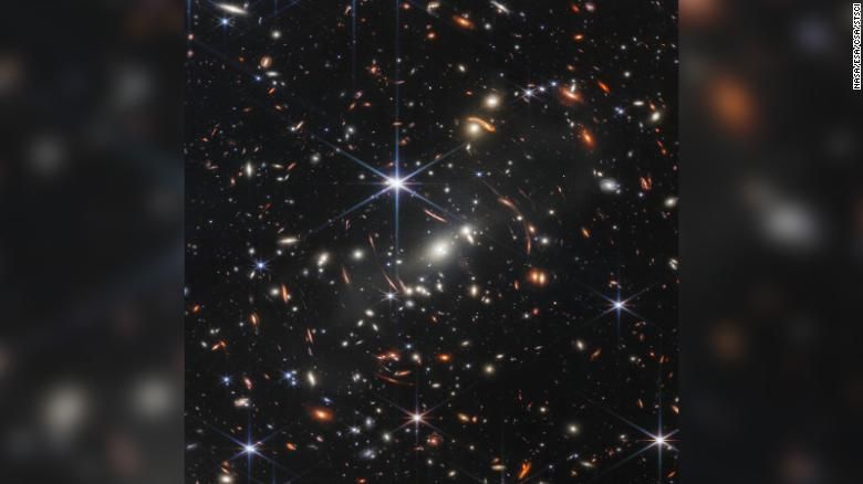 The James Webb Space Telescope's first deep field view was shared on Monday. The image shows SMACS 0723, where a massive group of galaxy clusters act as a magnifying glass for the objects behind them, including faint, distant galaxies.