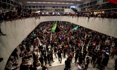 Protesters cheer after entering Iraq's parliament on Saturday.