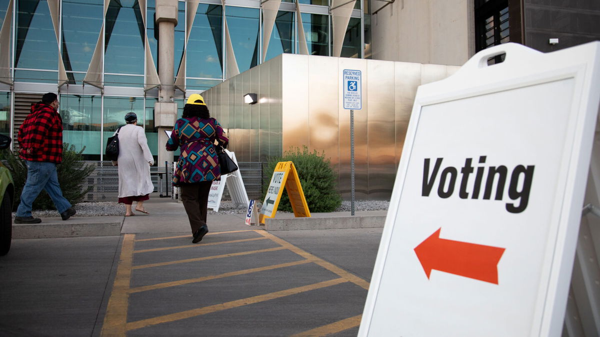 <i>Courtney Pedroza/Getty Images</i><br/>Voters enter Burton Barr Central Library to cast their ballots on November 3