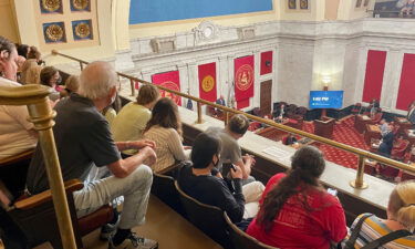 Members of the public watch the start of a West Virginia Senate hearing to discuss an abortion bill on July 29