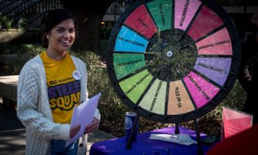 A Louisiana State University Street Squad peer educator shares information about safe sex practices with fellow students.