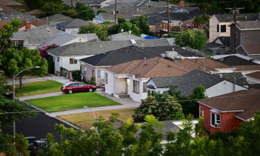 Green grass lawns are seen in front of homes in Los Angeles on July 5. Mortgage rates dropped last week