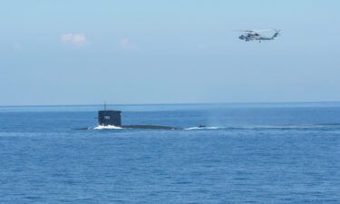 A helicopter and a submarine take part in Taiwan's live-fire military drills on July 26.