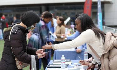 A job seeker meets with a recruiter during the Healthcare Academy career and training fair outside of the Chase Center on June 03