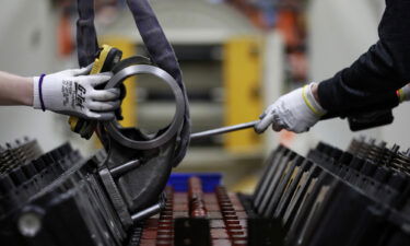 Workers assemble components on a diesel engine at the Cummins Seymour Engine Plant in Seymour