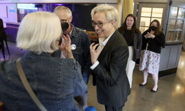 Oregon Democratic gubernatorial candidate Tina Kotek (C) speaks to supporters before the results of Oregon's primary election are announced in May. A historic number of LGBTQ candidates are running for office this year.