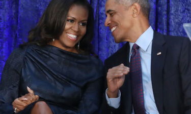 Former U.S. President Barack Obama and first lady Michelle Obama participate in the unveiling of their official portraits during a ceremony at the Smithsonian's National Portrait Gallery