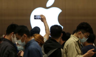 Customers line up to enter a new Apple store on May 21 in Wuhan