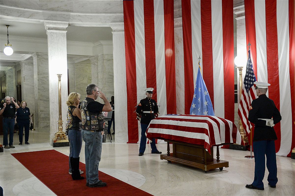 <i>Chris Dorst/Charleston Gazette-Mail/AP</i><br/>People salute the casket of Hershel 