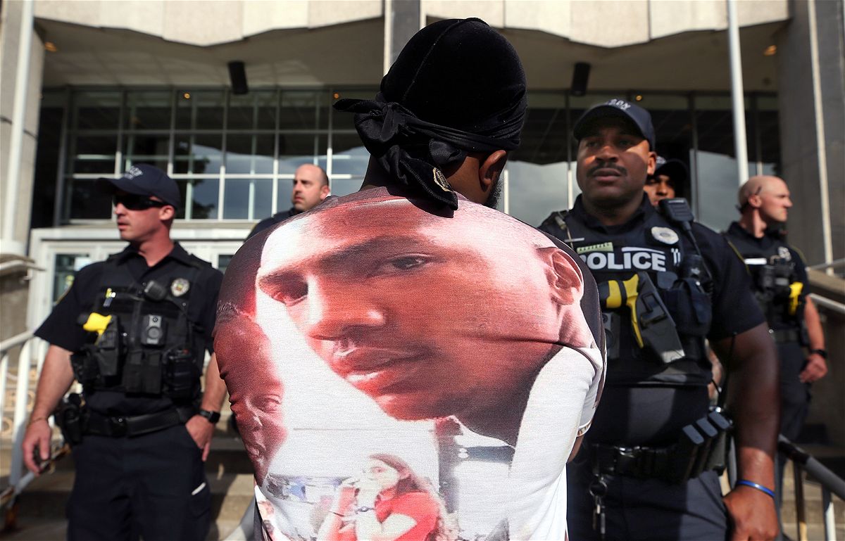 July 2, 2022; Akron, OH, USA; A protester stares down an Akron Police officer outside the Harold K. Stubbs Justice Center during a demonstration after Akron Police officers shot and killed Jayland Walker earlier in the week. Mandatory Credit: Jeff Lange-USA TODAY NETWORK