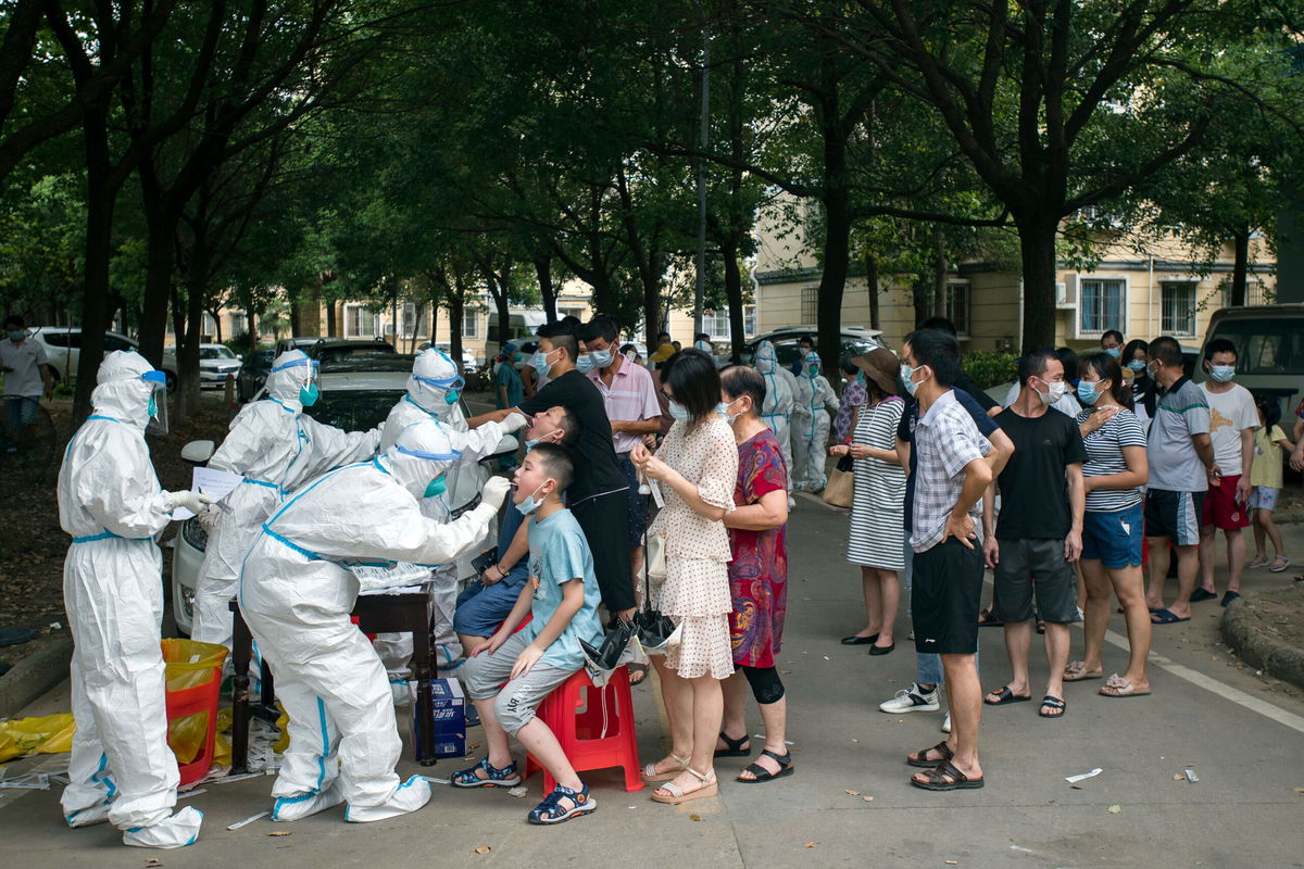 <i>Chinatopix/AP</i><br/>Residents line up to be tested for Covid-19 in Wuhan