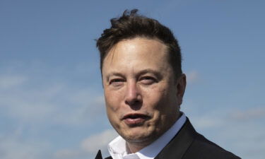 Tesla head Elon Musk talks to the press as he arrives to have a look at the construction site of the new Tesla Gigafactory near Berlin on September 03