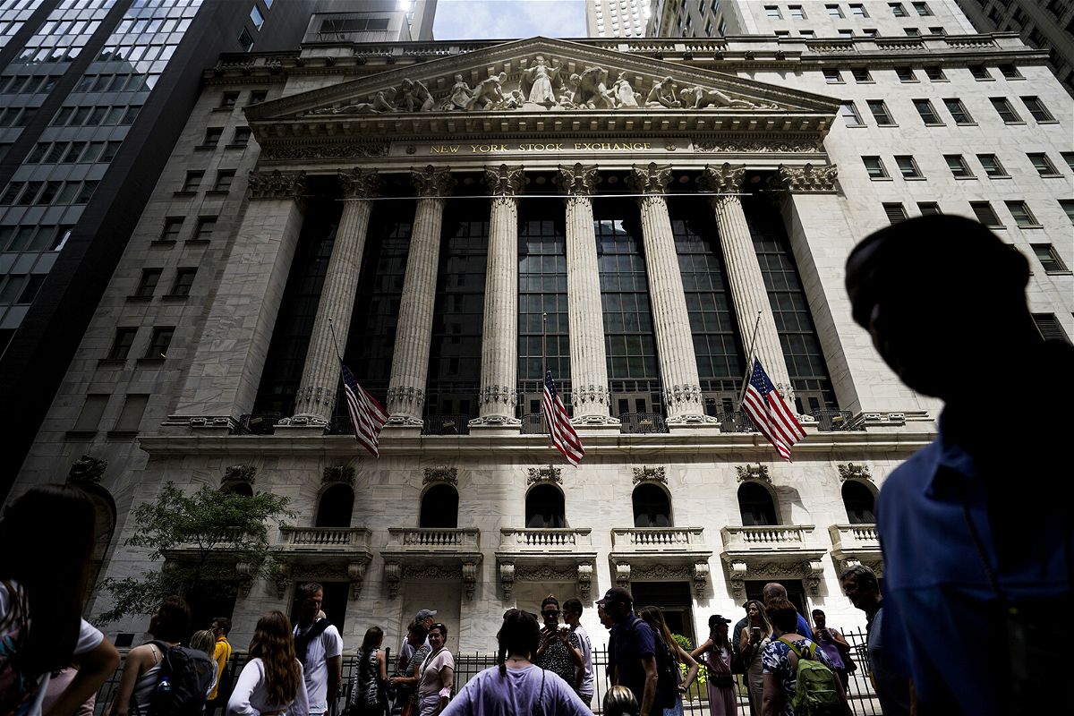 <i>John Minchillo/AP</i><br/>Pedestrians walk past the New York Stock Exchange on  Friday