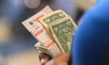 People wait in line at Blue Bird Liquor store to purchase Mega Millions lottery tickets Friday in Hawthorne