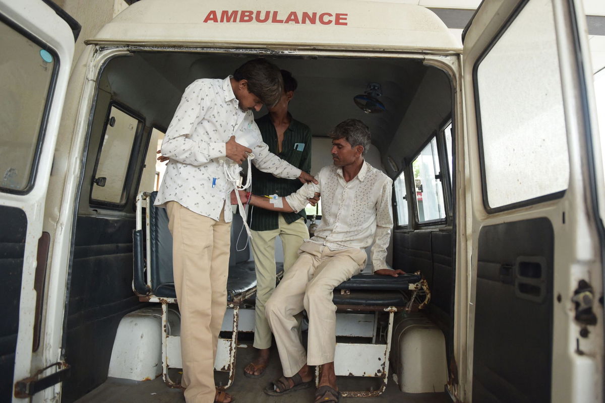 <i>Sam Panthaky/AFP/Getty Images</i><br/>A man arrives at the Civil Hospital in Ahmedabad on July 26 after consuming bootleg liquor.