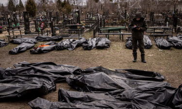 A man works to catalog some of 58 bodies of civilians killed in and around Bucha before they are transported to the morgue at a cemetery on April 6 in Bucha