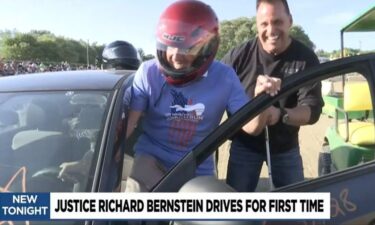 Genesee County Sheriff Chris Swanson (R) helped Michigan Supreme Court Justice Richard Bernstein take a spin at the Genesee County Fairgrounds Tuesday