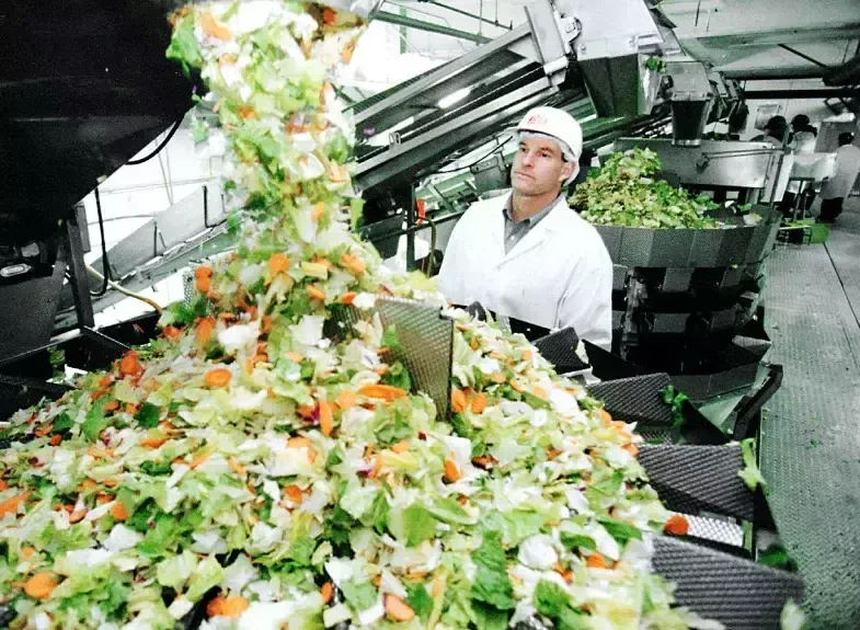 Steve Taylor looks over a salad packaging machine at the Fresh Express packaging plant in Salinas in 1999. (AP Photo/John Todd)