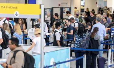 Travelers line up to enter a security checkpoint at Newark Liberty International Airport (EWR) on July 1 in Newark