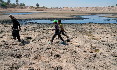 People cross the Diyala River