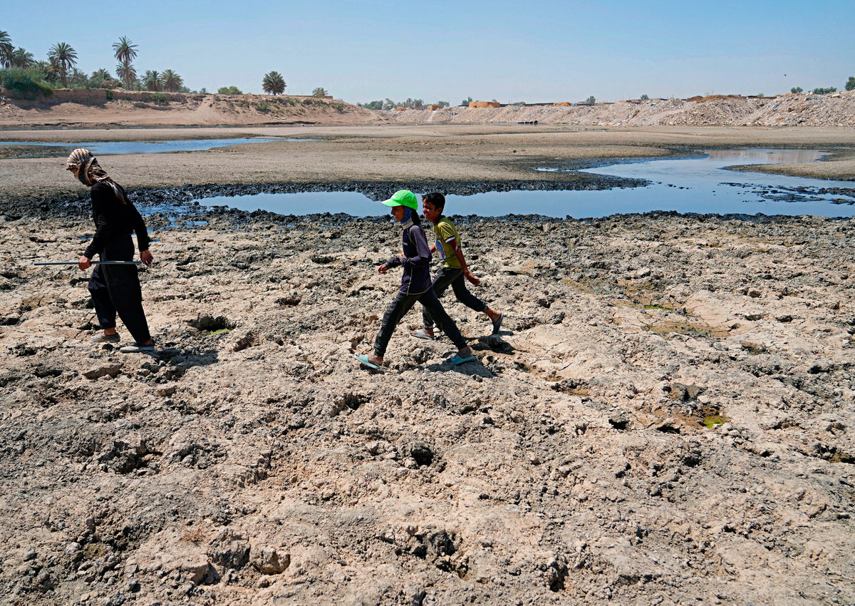 <i>Hadi Mizban/AP</i><br/>People cross the Diyala River