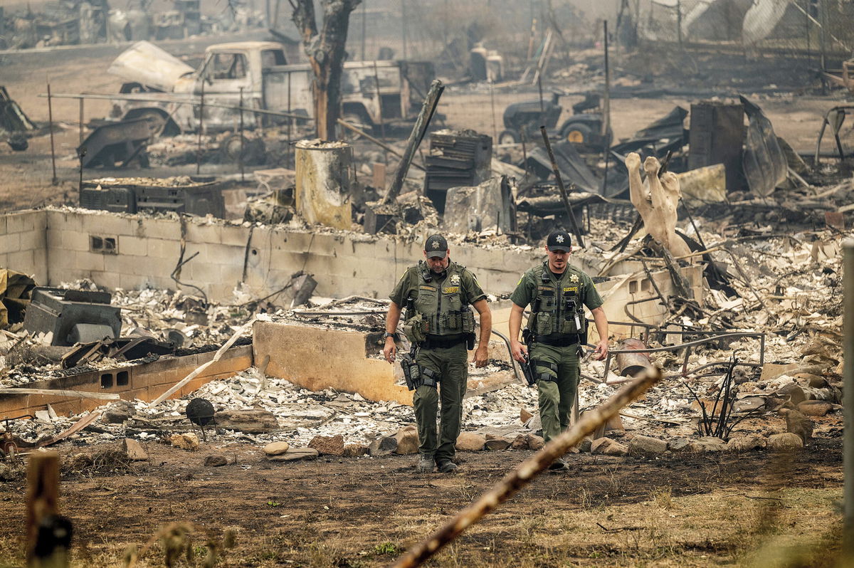 <i>Noah Berger/AP</i><br/>Officials have identified four people killed in the McKinney Fire in California as residents of the same community. Sheriff's deputies leave a home where a McKinney Fire victim was found on August 1