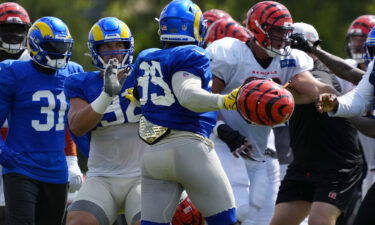 Los Angeles Rams defensive lineman Aaron Donald (99) swings a helmet during a joint practice between the Bengals and the Rams in Cincinnati.