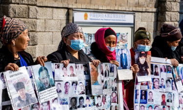 Gulnur Kosdaulet protests her husband's detention in China outside the Chinese consulate in Kazakhstan's largest city Almaty in March 2021. Outgoing UN rights chief Michelle Bachelet released a controversial report on Xinjiang on August 31.