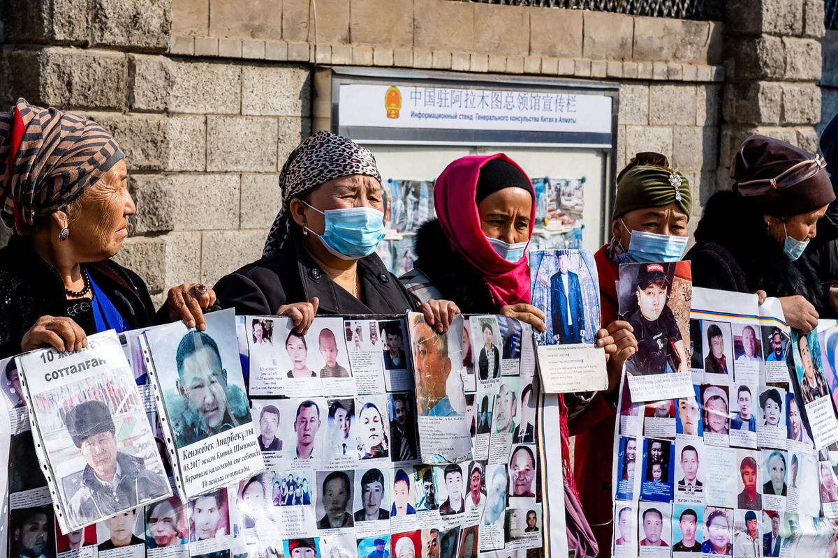 <i>Abduaziz Madyarov/AFP/Getty Images</i><br/>Gulnur Kosdaulet protests her husband's detention in China outside the Chinese consulate in Kazakhstan's largest city Almaty in March 2021. Outgoing UN rights chief Michelle Bachelet released a controversial report on Xinjiang on August 31.