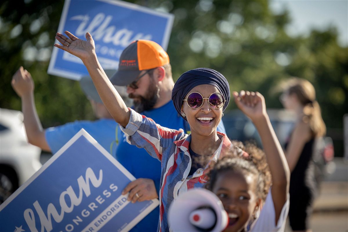 <i>Elizabeth Flores/AP</i><br/>US Rep. Ilhan Omar waves to passersby for support during a voter engagement event on the corner of Broadway and Central Avenues in Minneapolis