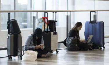 Travelers are pictured at LaGuardia Airport (LGA) in the Queens borough of New York