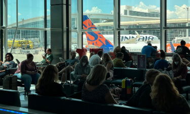 Passengers wait in a terminal at Dallas-Fort Worth International Airport (DFW) on Aug. 11