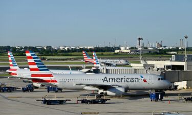 American Airlines says it is cutting 2% of flights from its schedule in September and October. Planes are seen here in June at its hub in Philadelphia