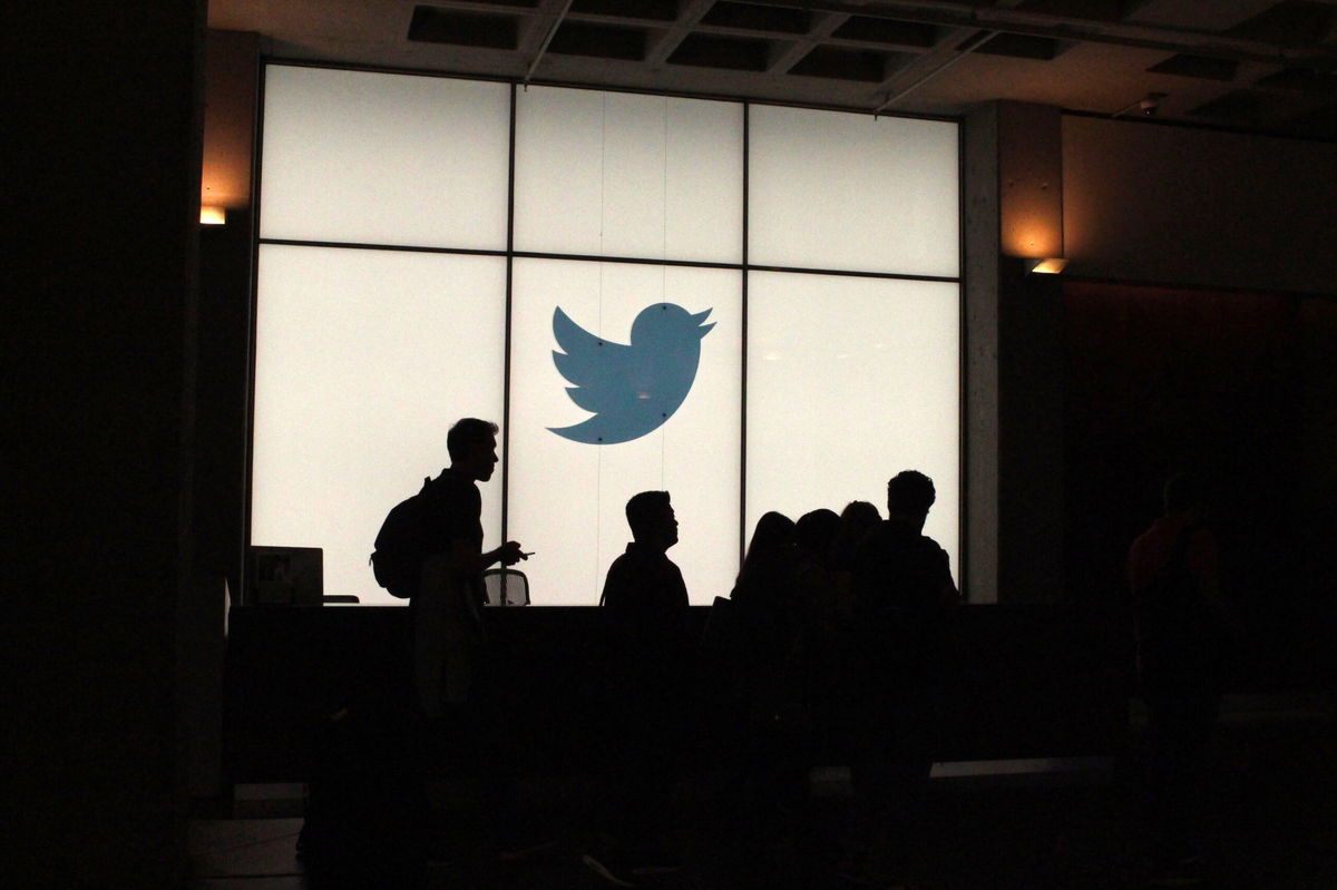 <i>Glenn Chapman/AFP/Getty Images</i><br/>Twitter employees walk by the company's headquarters in San Francisco