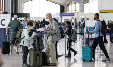 Travelers line up to check in for United Airlines flights at Newark Liberty International Airport (EWR) on July 1