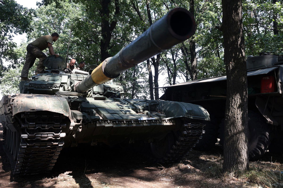 <i>Anatolii Stepanov/AFP/Getty Images</i><br/>Ukrainian soldiers stand on their tank at the front line in the Donetsk region on August 19