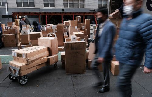 Dozens of packages are lined up along a Manhattan street as a FedEx truck makes deliveries on December 06