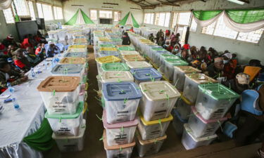 Kenya's electoral officials (left) wait to hand over presidential election results in Nairobi on August 12. The electoral officials blamed the delay in announcing the results on candidates' agents for slowing down the national tally of votes.