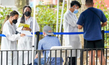 Healthcare workers with the New York City Department of Health and Mental Hygiene help people register for the monkeypox vaccine at a city vaccination site on July 26.