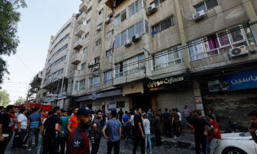 Palestinians gather next to the site of an Israeli strike in Gaza City on August 5.