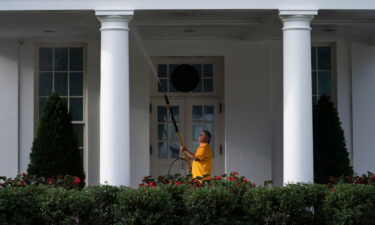 A maintenance worker power washes the West Wing of the White House on August 7.