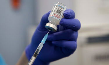 A health worker draws the Moderna Covid-19 vaccine as she prepares to administer a booster shot. The UK has become the first country to approve an updated version of Moderna's Covid-19 vaccine booster that targets the Omicron strain and the original virus from 2020.